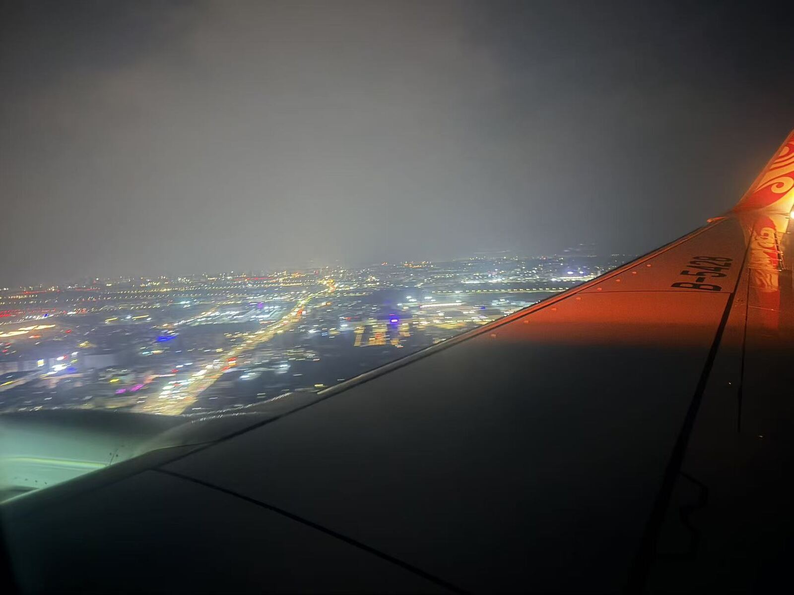City lights of Guangzhou seen from the plane window on descent